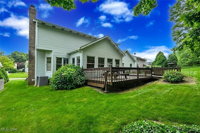 452 Herbert Rd, Akron, OH 44312 - rear view of house featuring a chimney, a yard, a wooden deck, and central AC