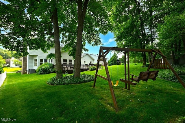 452 Herbert Rd, Akron, OH 44312 - view of grassy yard featuring a playground, central AC, and a deck