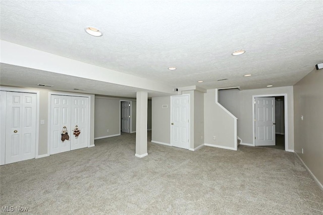 452 Herbert Rd, Akron, OH 44312 - finished basement featuring a textured ceiling, carpet, baseboards, stairway, and recessed lighting