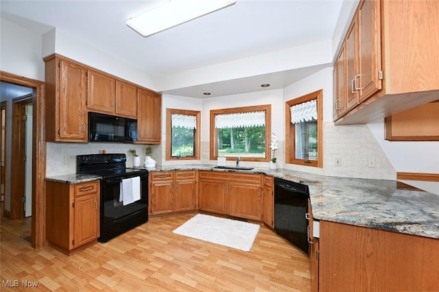 452 Herbert Rd, Akron, OH 44312 - kitchen with black appliances, a sink, decorative backsplash, light wood-style flooring, and light stone countertops