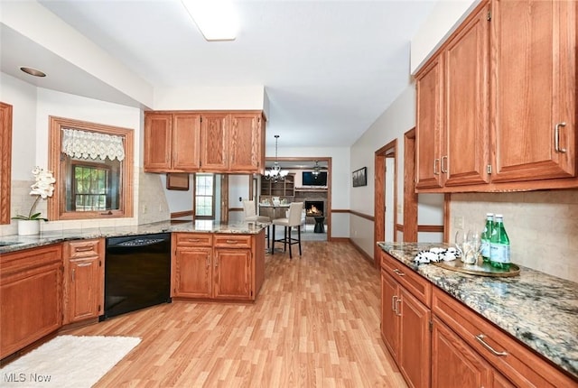 452 Herbert Rd, Akron, OH 44312 - kitchen featuring dishwasher, light wood-type flooring, backsplash, and brown cabinets