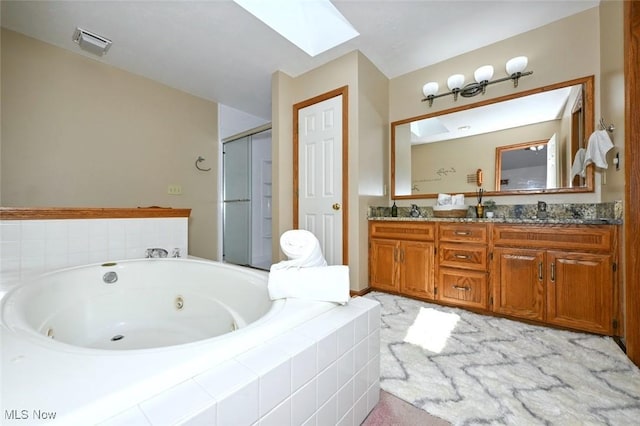 452 Herbert Rd, Akron, OH 44312 - bathroom featuring a skylight, a tub with jets, a stall shower, and double vanity