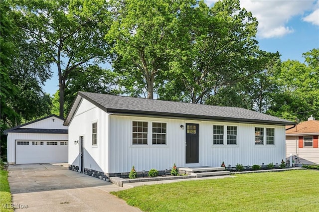178 Lindsey Rd, Munroe Falls, OH 44262 - single story home with an outbuilding, a front yard, a detached garage, and roof with shingles