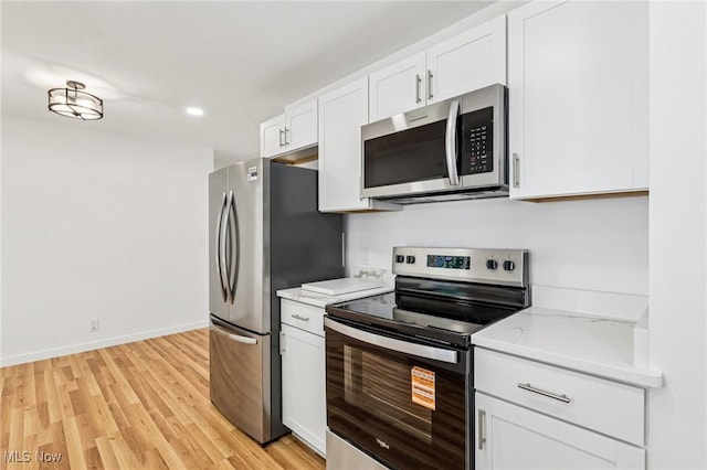 178 Lindsey Rd, Munroe Falls, OH 44262 - kitchen featuring appliances with stainless steel finishes, white cabinetry, light wood finished floors, recessed lighting, and baseboards