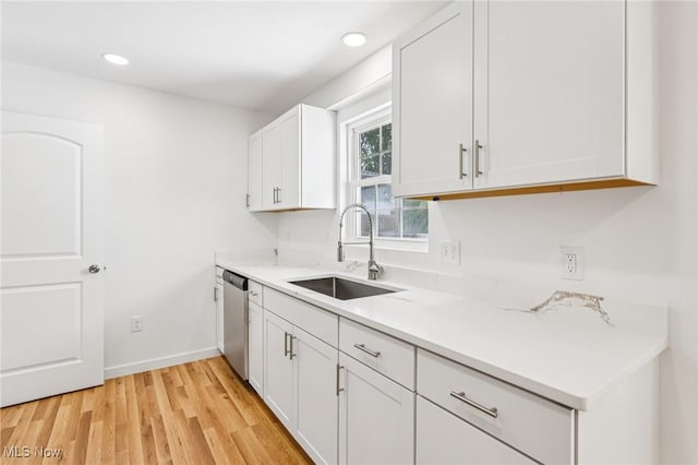 178 Lindsey Rd, Munroe Falls, OH 44262 - kitchen with a sink, stainless steel dishwasher, white cabinets, light wood-style floors, and light countertops