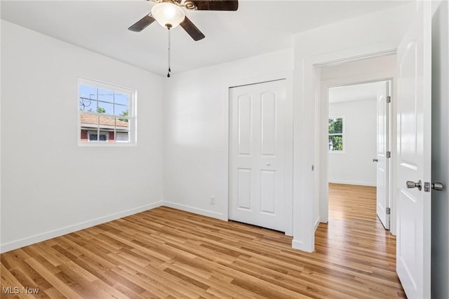 178 Lindsey Rd, Munroe Falls, OH 44262 - unfurnished bedroom with light wood-style flooring, multiple windows, baseboards, and a closet