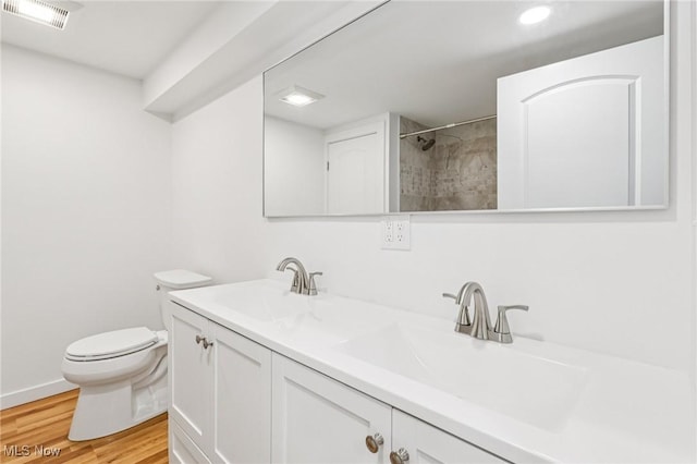 178 Lindsey Rd, Munroe Falls, OH 44262 - full bath with double vanity, toilet, wood finished floors, tiled shower, and recessed lighting