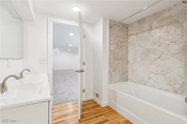 178 Lindsey Rd, Munroe Falls, OH 44262 - bathroom with double vanity, wood finished floors, shower / bathtub combination, baseboards, and recessed lighting