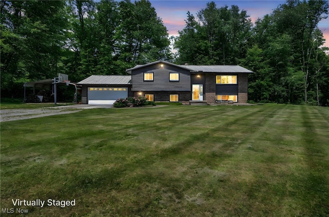 11996 Bower Rd, Minerva, OH 44657 - view of front of property with a yard, a garage, dirt driveway, and metal roof