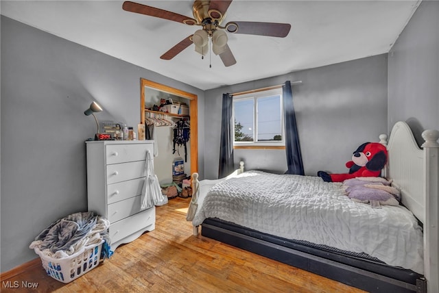 11996 Bower Rd, Minerva, OH 44657 - bedroom with a closet, wood finished floors, and a ceiling fan