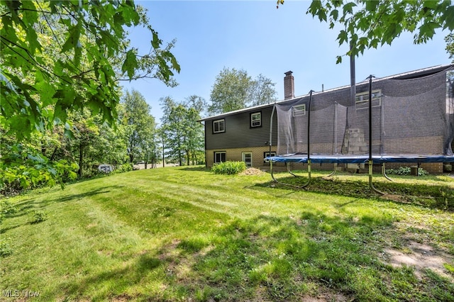 11996 Bower Rd, Minerva, OH 44657 - view of grassy yard featuring a trampoline
