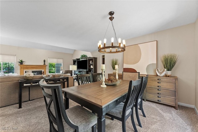 10378 N Pond Ln N Unit 2, Twinsburg, OH 44087 - dining space featuring light colored carpet, a fireplace, and a chandelier