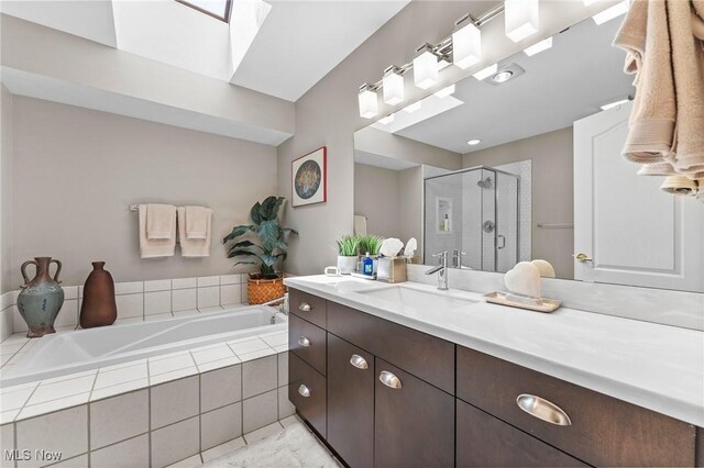 10378 N Pond Ln N Unit 2, Twinsburg, OH 44087 - full bathroom with vanity, a bath, a shower stall, and a skylight