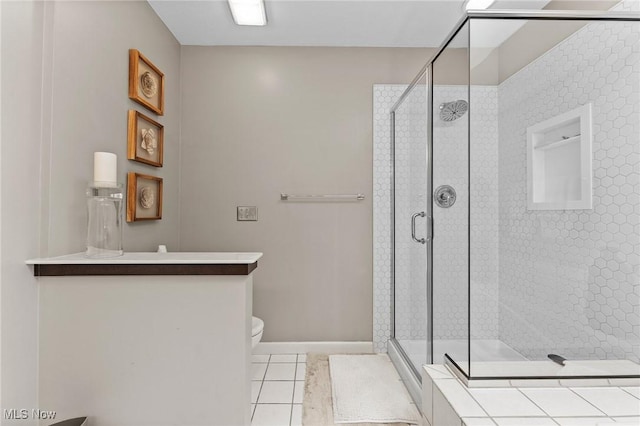 10378 N Pond Ln N Unit 2, Twinsburg, OH 44087 - full bath featuring a stall shower, tile patterned flooring, toilet, and baseboards