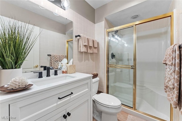 10378 N Pond Ln N Unit 2, Twinsburg, OH 44087 - full bathroom featuring tile walls, toilet, a stall shower, and vanity