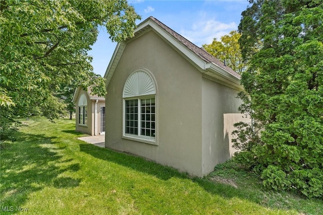 10378 N Pond Ln N Unit 2, Twinsburg, OH 44087 - view of side of home with stucco siding and a yard