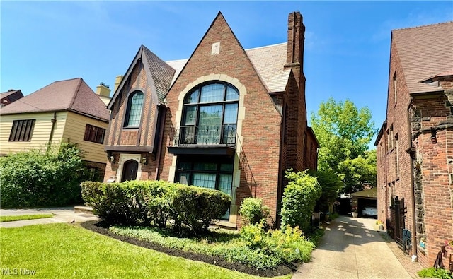 19627 Winslow Rd, Shaker Heights, OH 44122 - tudor-style house featuring brick siding and a chimney