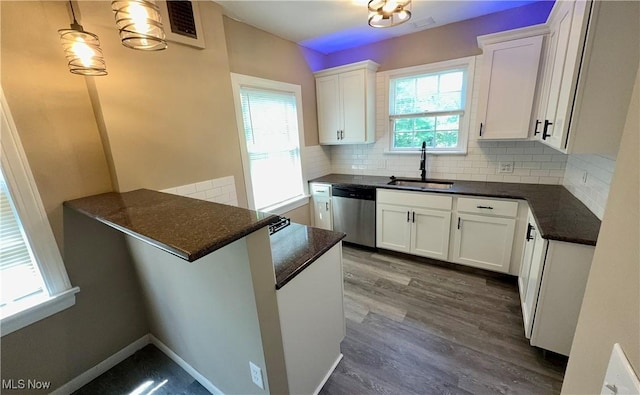 19627 Winslow Rd, Shaker Heights, OH 44122 - kitchen with stainless steel dishwasher, a sink, white cabinetry, tasteful backsplash, and dark wood-style flooring