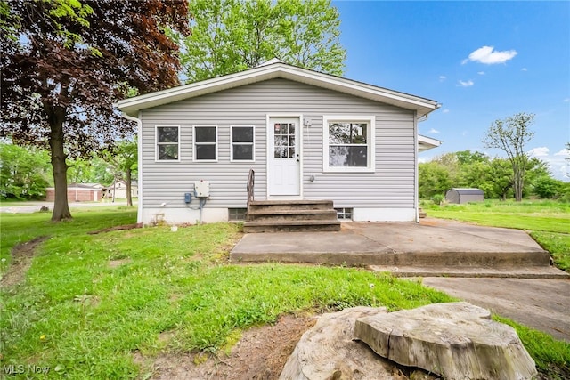 4241 Greenville Rd, Cortland, OH 44410 - bungalow featuring a front lawn and a patio area
