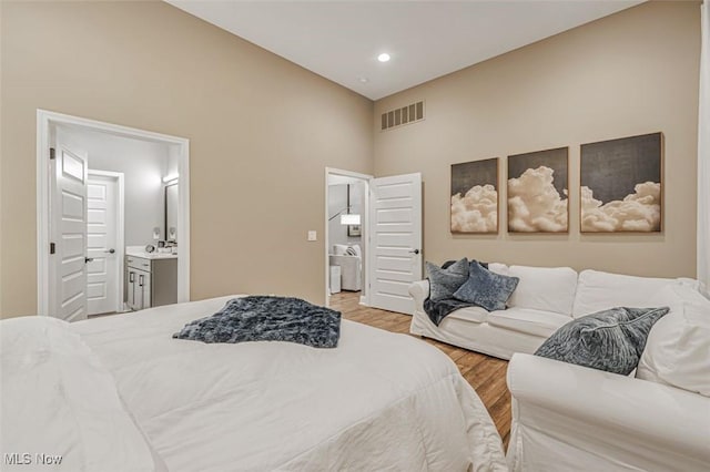 614 N 11th St, Cambridge, OH 43725 - bedroom with light wood-style floors, ensuite bath, and a high ceiling