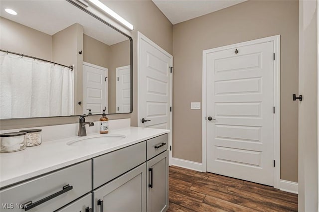 614 N 11th St, Cambridge, OH 43725 - bathroom with vanity, wood finished floors, and baseboards
