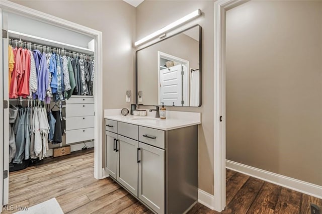 614 N 11th St, Cambridge, OH 43725 - full bath featuring vanity, wood finished floors, baseboards, and a walk in closet