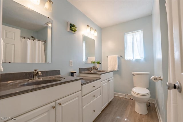 14222 Wade Ave NE, Hartville, OH 44632 - full bath featuring vanity, wood finished floors, toilet, and baseboards