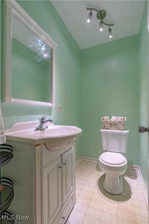14222 Wade Ave NE, Hartville, OH 44632 - bathroom featuring toilet, vanity, and baseboards
