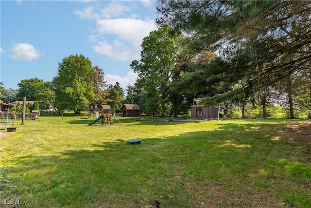 14222 Wade Ave NE, Hartville, OH 44632 - view of green lawn with a playground and view of wooded area