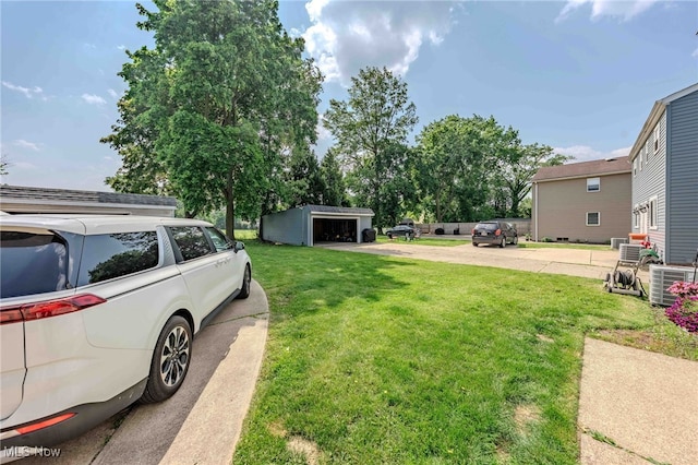 3357-3359 Rocky River Dr, Cleveland, OH 44111 - view of green lawn featuring a garage, central air condition unit, and driveway