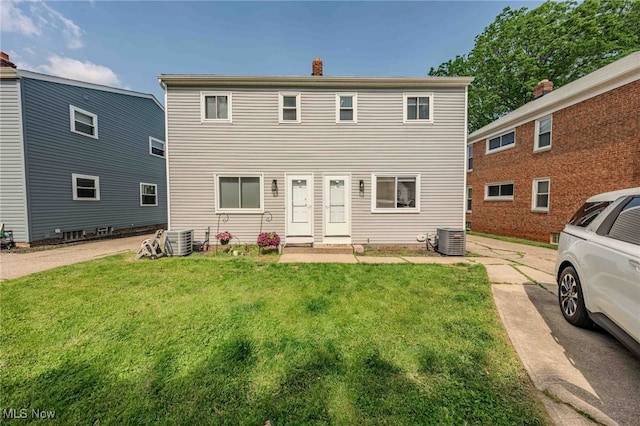 3357-3359 Rocky River Dr, Cleveland, OH 44111 - rear view of property featuring cooling unit, a lawn, and a chimney