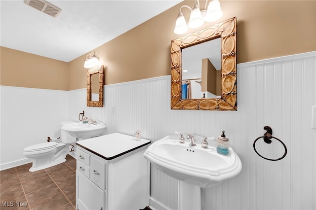 23789 Snell Rd, Columbia Station, OH 44028 - bathroom with wainscoting, toilet, tile patterned flooring, and a sink