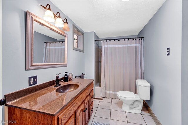 23789 Snell Rd, Columbia Station, OH 44028 - full bath featuring vanity, toilet, tile patterned flooring, shower / bath combo with shower curtain, and baseboards