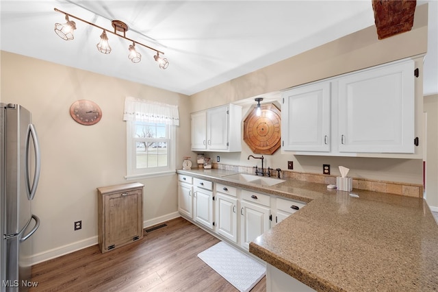 23789 Snell Rd, Columbia Station, OH 44028 - kitchen featuring freestanding refrigerator, a sink, white cabinets, and baseboards