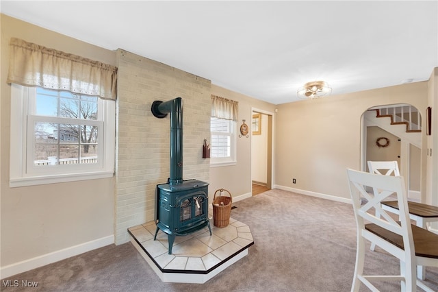 23789 Snell Rd, Columbia Station, OH 44028 - carpeted living room with a wood stove, baseboards, and arched walkways