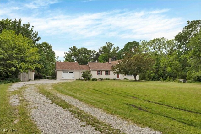 23789 Snell Rd, Columbia Station, OH 44028 - view of front of property with driveway, a front yard, an attached garage, and a storage shed