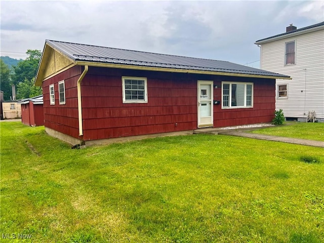 818 2nd St, Brilliant, OH 43913 - view of front of house with a front lawn and metal roof