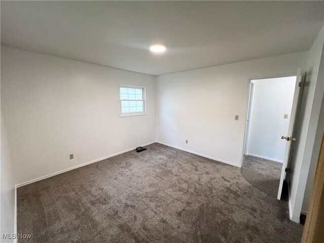 818 2nd St, Brilliant, OH 43913 - empty room with dark carpet and baseboards