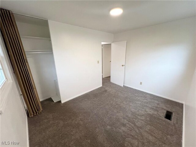 818 2nd St, Brilliant, OH 43913 - unfurnished bedroom featuring dark carpet, a closet, and baseboards