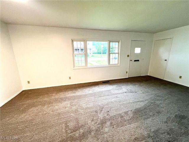 818 2nd St, Brilliant, OH 43913 - unfurnished living room featuring dark carpet and baseboards