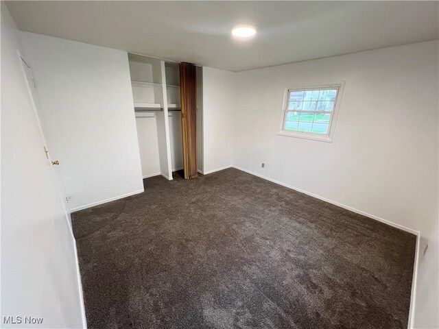 818 2nd St, Brilliant, OH 43913 - unfurnished bedroom with dark carpet, a closet, and baseboards
