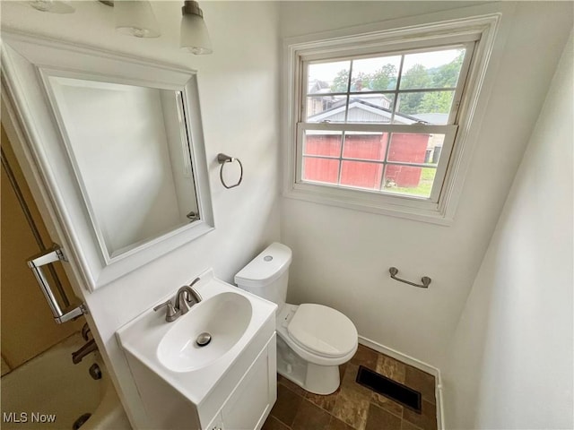 818 2nd St, Brilliant, OH 43913 - bathroom featuring toilet, vanity, stone finish flooring, and a tub to relax in
