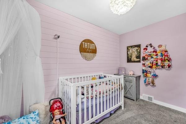 23 Sprague Rd, Berea, OH 44017 - bedroom with carpet, a nursery area, baseboards, and wood walls