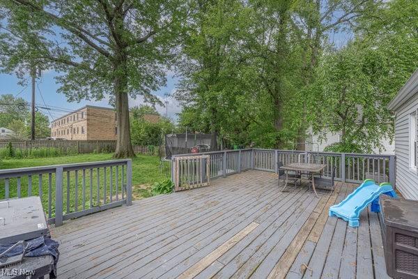 23 Sprague Rd, Berea, OH 44017 - wooden deck featuring outdoor dining space and a trampoline
