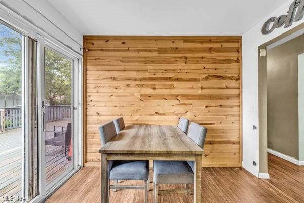 23 Sprague Rd, Berea, OH 44017 - dining room featuring baseboards, light wood finished floors, and wooden walls