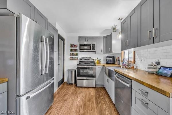 23 Sprague Rd, Berea, OH 44017 - kitchen with stainless steel appliances, gray cabinetry, wood counters, and tasteful backsplash