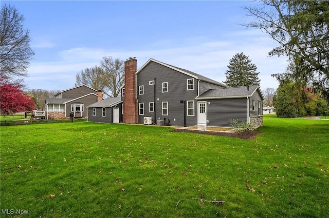 5433 Fleetwood Ave NW, Canton, OH 44718 - rear view of property featuring a lawn, a chimney, and cooling unit