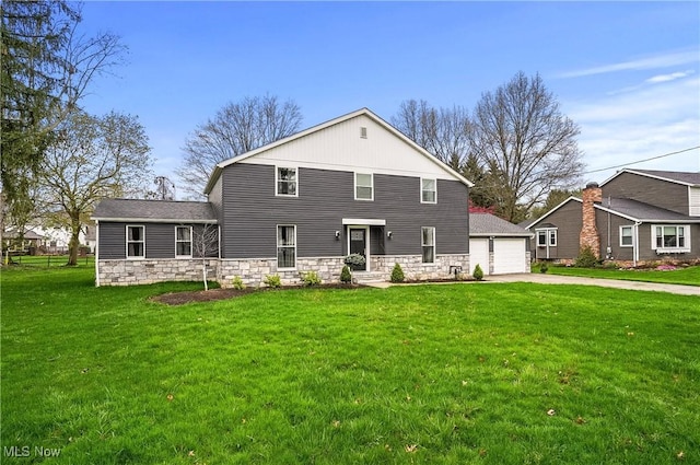5433 Fleetwood Ave NW, Canton, OH 44718 - back of house with driveway, a yard, stone siding, and a garage