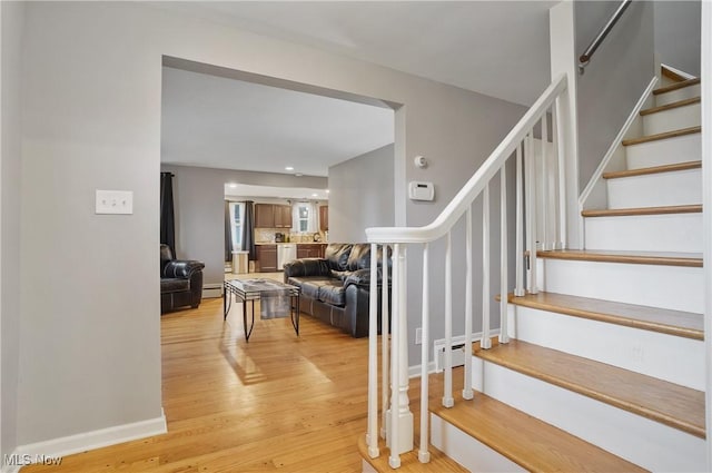 5433 Fleetwood Ave NW, Canton, OH 44718 - stairway with wood finished floors, recessed lighting, and a baseboard radiator