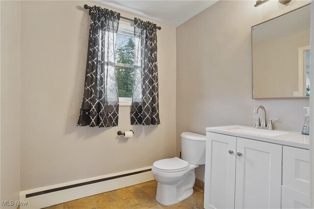 5433 Fleetwood Ave NW, Canton, OH 44718 - half bathroom featuring baseboard heating, vanity, toilet, and baseboards